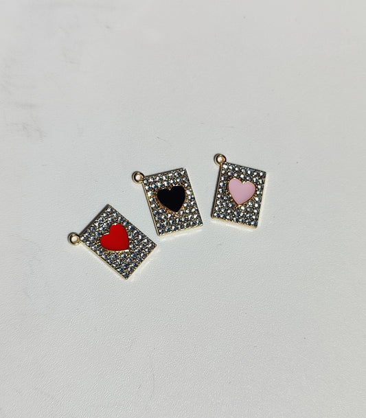 Set of three heart charms in gold frames with red, black, and pink enamel accents for personalized jewelry.