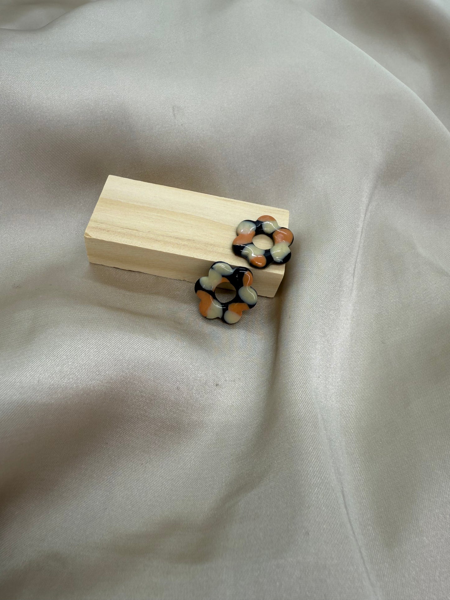 boucles d'oreilles personnalisables en formes de fleurs de 2,5cm environ avec six branches en pâte polymère, couleur noir avec des tâches beige et orange.
possibilité de nous demander d'autres couleurs.